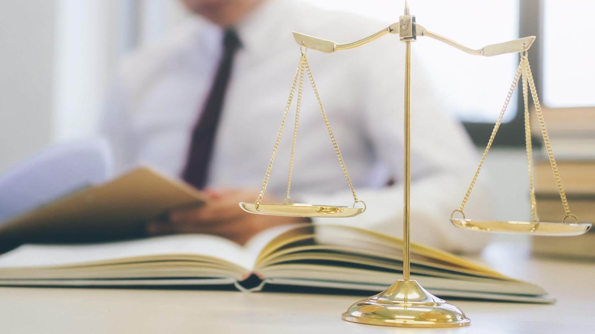 Legal scale sitting on the desk of a personal injury attorney