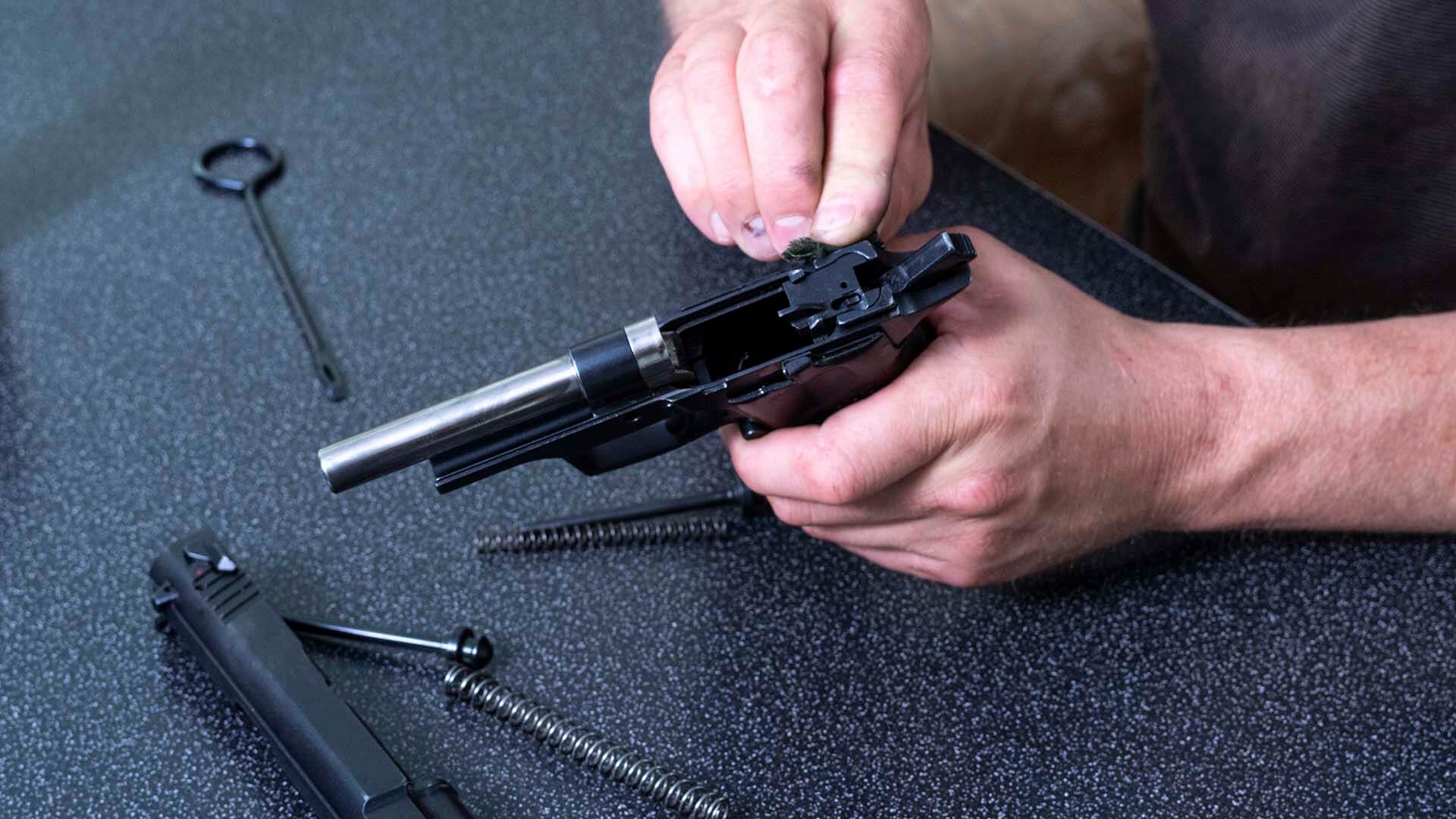 Product liability attorney inspecting a defective gun