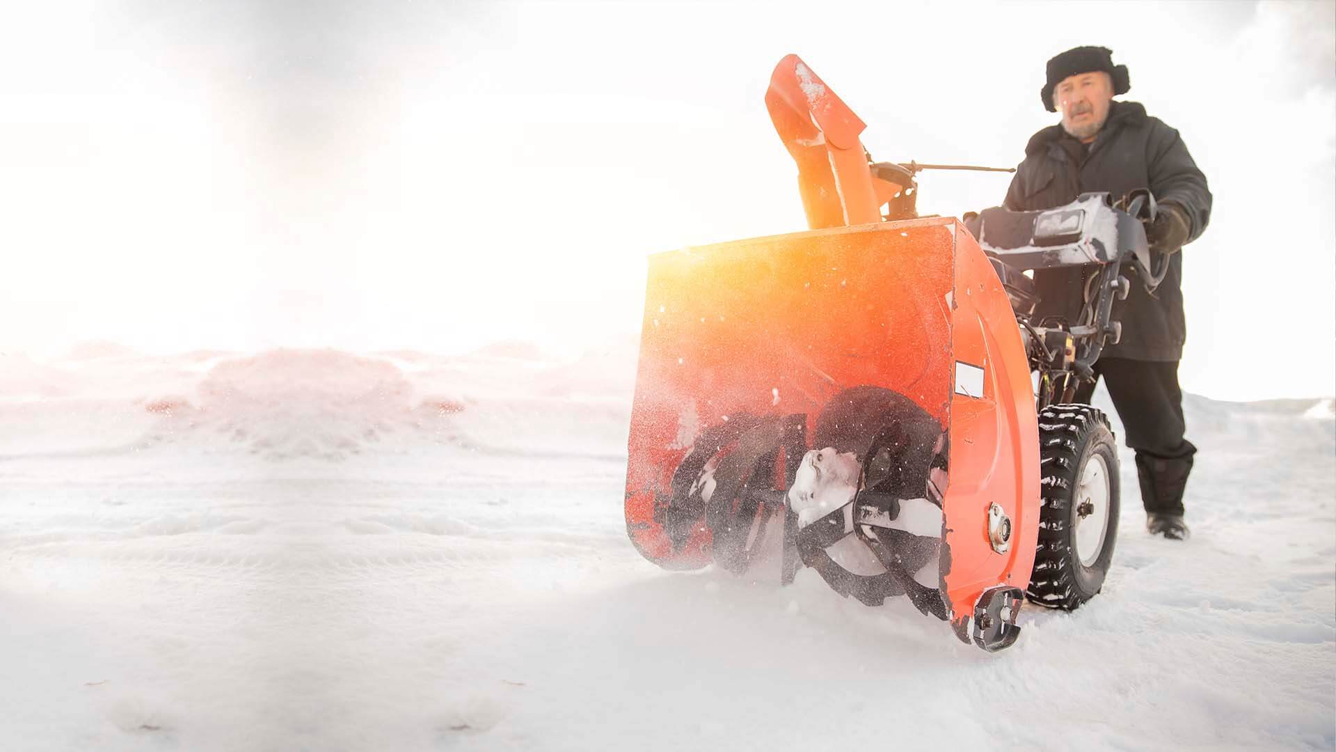 A man using a potentially dangerous or defective snow blower