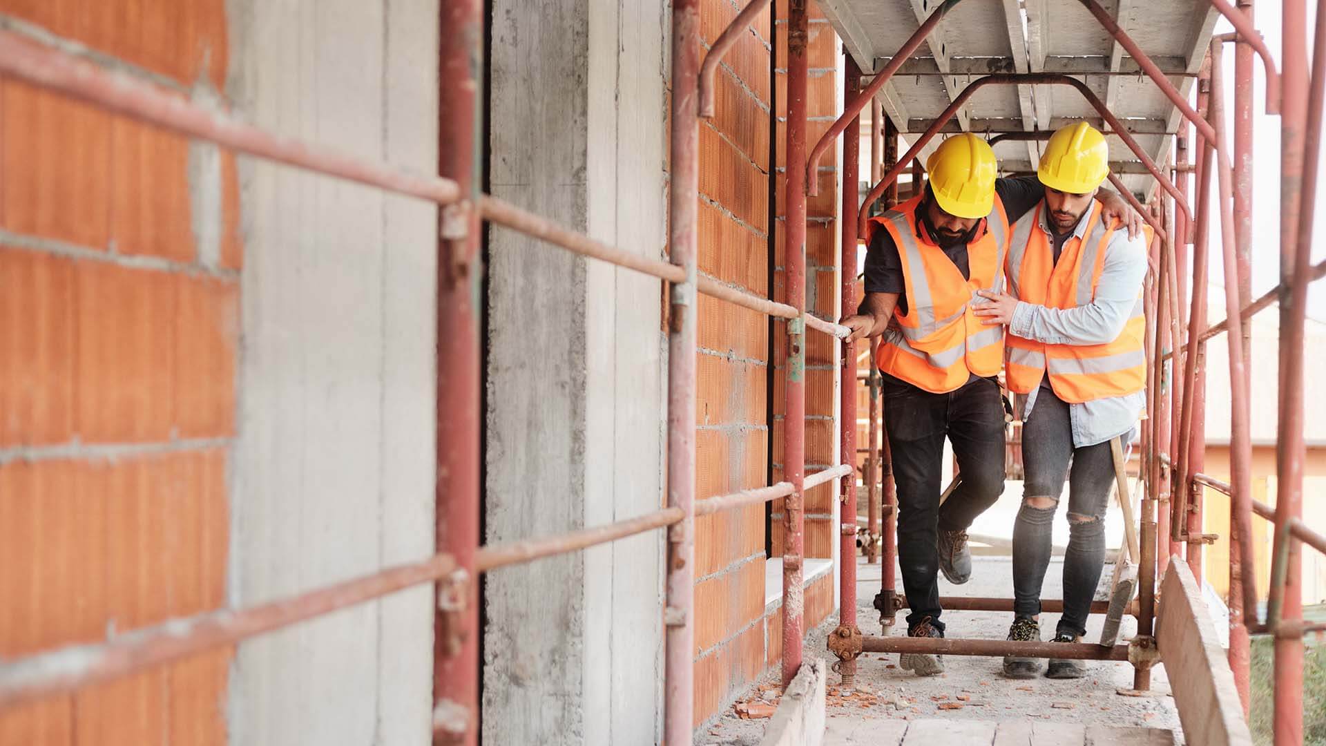 Construction worker injured on job being assisted by co-worker on their way to file a wokers' compensation claim with a personal injury attorney